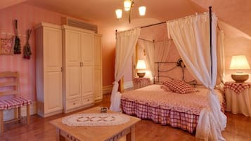 A bedroom with a four-poster bed, a wooden nightstand, a chair, and a wardrobe.