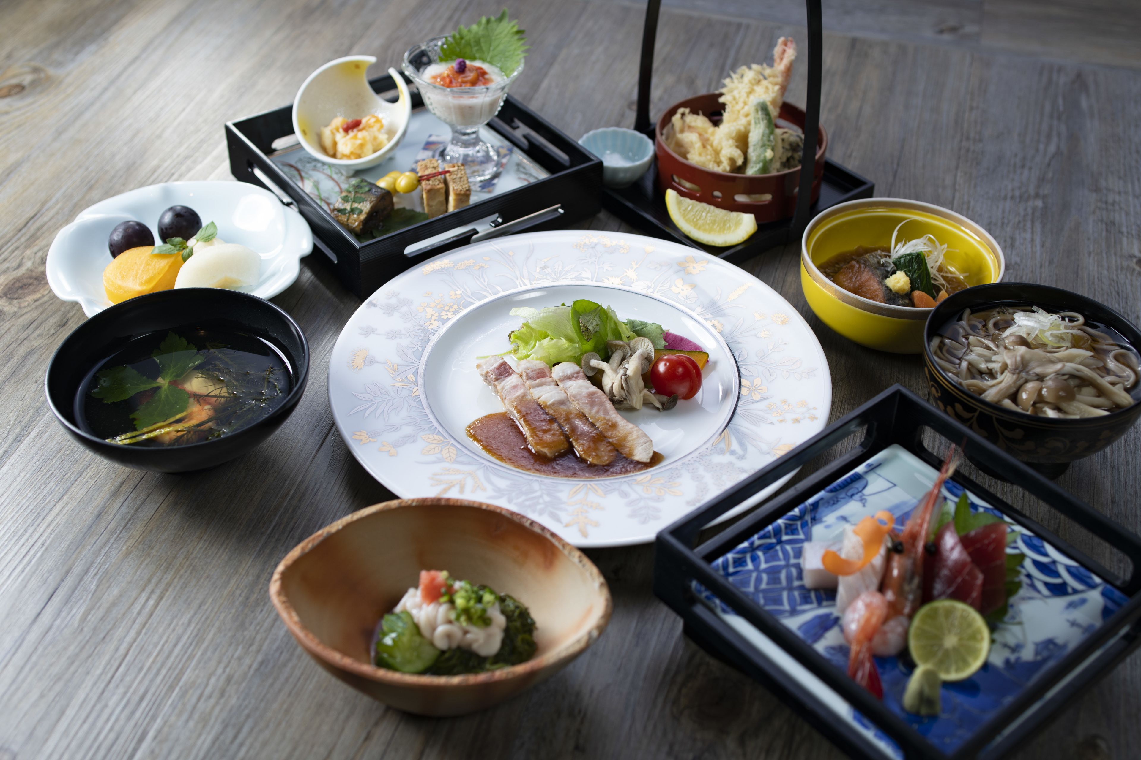 A variety of dishes on a wooden table, including seafood, vegetables, and a dessert.