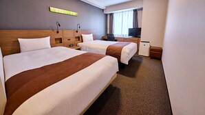 A hotel room with two beds, a desk, a television, and a small refrigerator. - Smile Hotel PREMIUM SAPPOROSUSUKINO (Sapporo)