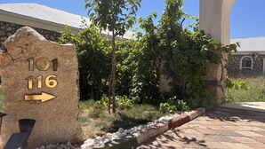 A stone sign with numbers '101' and '116' and an arrow pointing right, indicating a direction or location. - Nemrut Euphrat Hotel (Kahta)