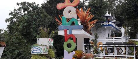 A colorful alphabet sculpture with a pagoda-style building in the background.