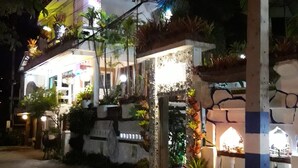 A building with a white facade, multiple balconies, and a well-lit entrance. - Ban Thor Phan (Sangkhla Buri)