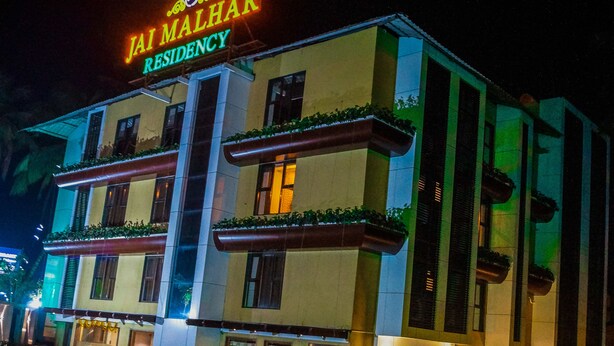A multi-story building with a sign reading "Jai Malhar Residency." - Jai Malahar Residency (Panvel)