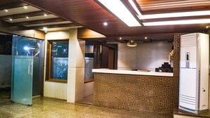 A modern kitchen with a built-in island, a refrigerator, and a window. - Jai Malahar Residency (Panvel)
