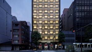A modern hotel with a grid of windows, a visible entrance, and a sign reading "Courtyard by Marriott". - Courtyard By Marriott Kyoto Shijo Karasuma (Kyoto)