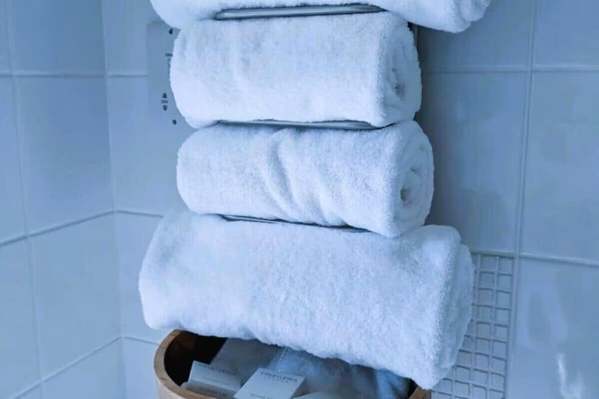 A stack of white towels on a wall.