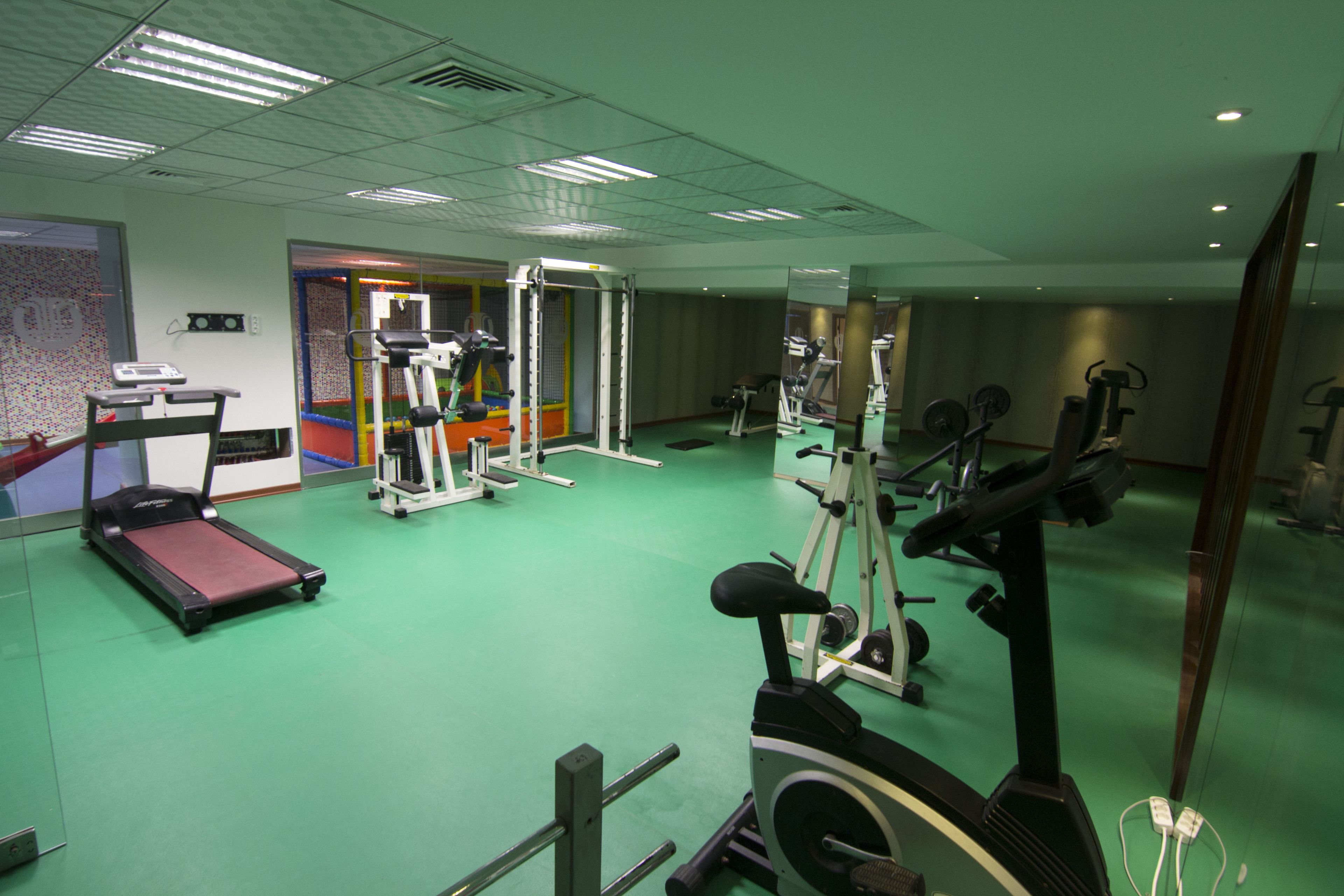 A gym with treadmills, stationary bikes, and weight machines.