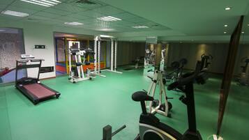 A gym with treadmills, stationary bikes, and weight machines.