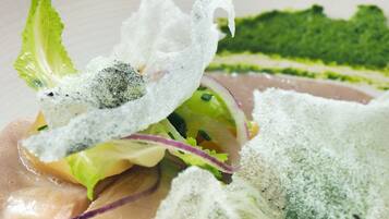 A dish with fish, greens, and a creamy sauce.