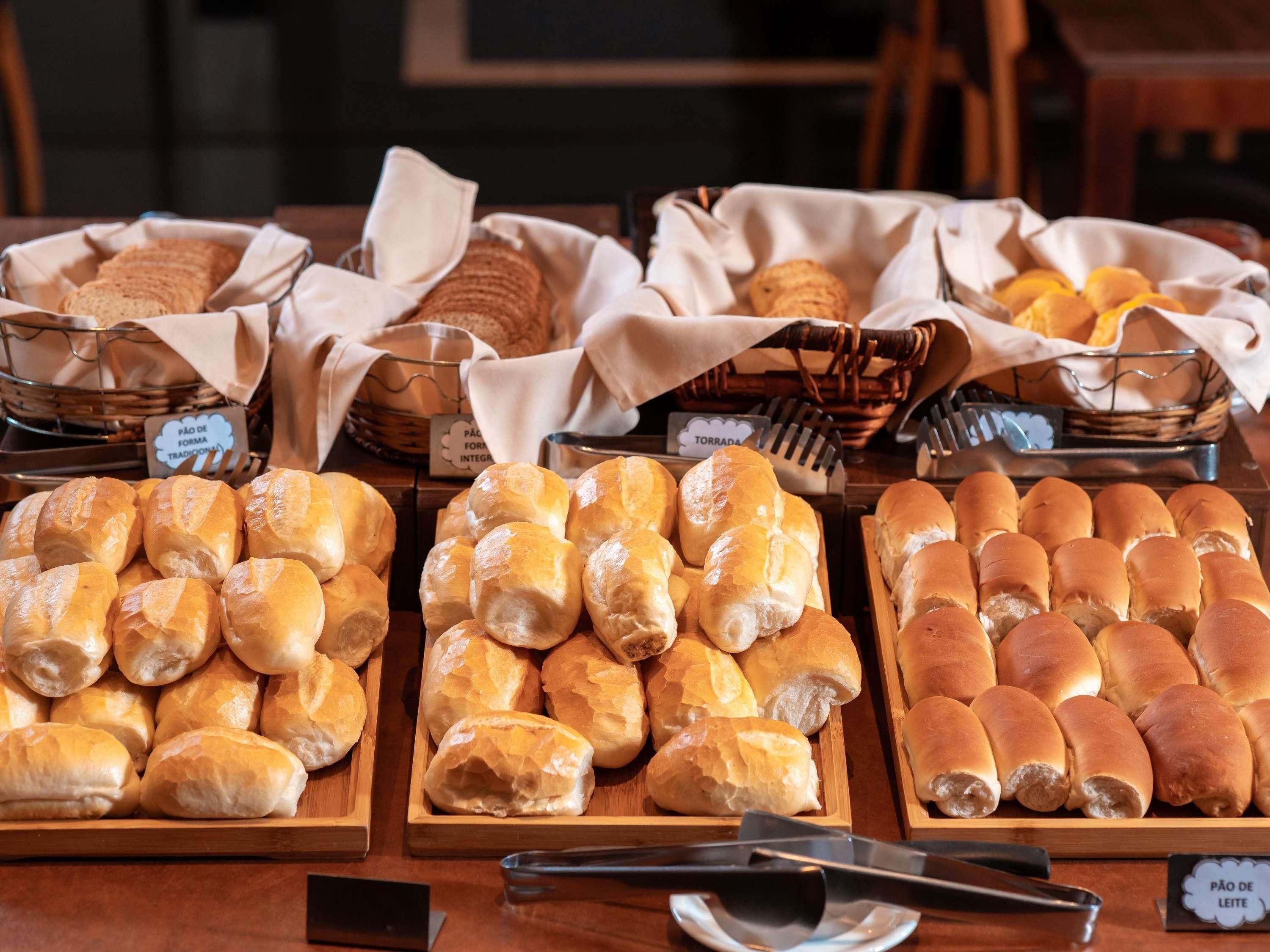 A bakery display with various types of bread and pastries.
