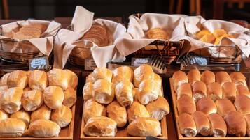 Una vitrina de panadería con distintos tipos de pan y pasteles.