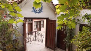 A traditional building with a white facade and a blue decorative element above the entrance. - Alafrangite Hotel (Plovdiv)