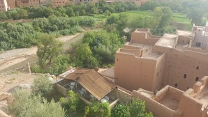 A traditional building with a courtyard, surrounded by greenery and a river. -  Les Jardins de Todgha (Toudgha El Oulia)