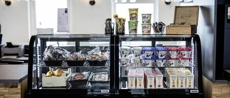 A deli display with various packaged foods and beverages.