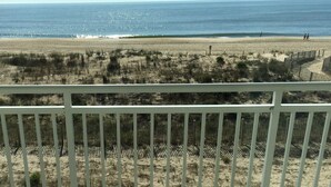 A beach view from a balcony with a white railing. - Worcester House 302 (Ocean City)