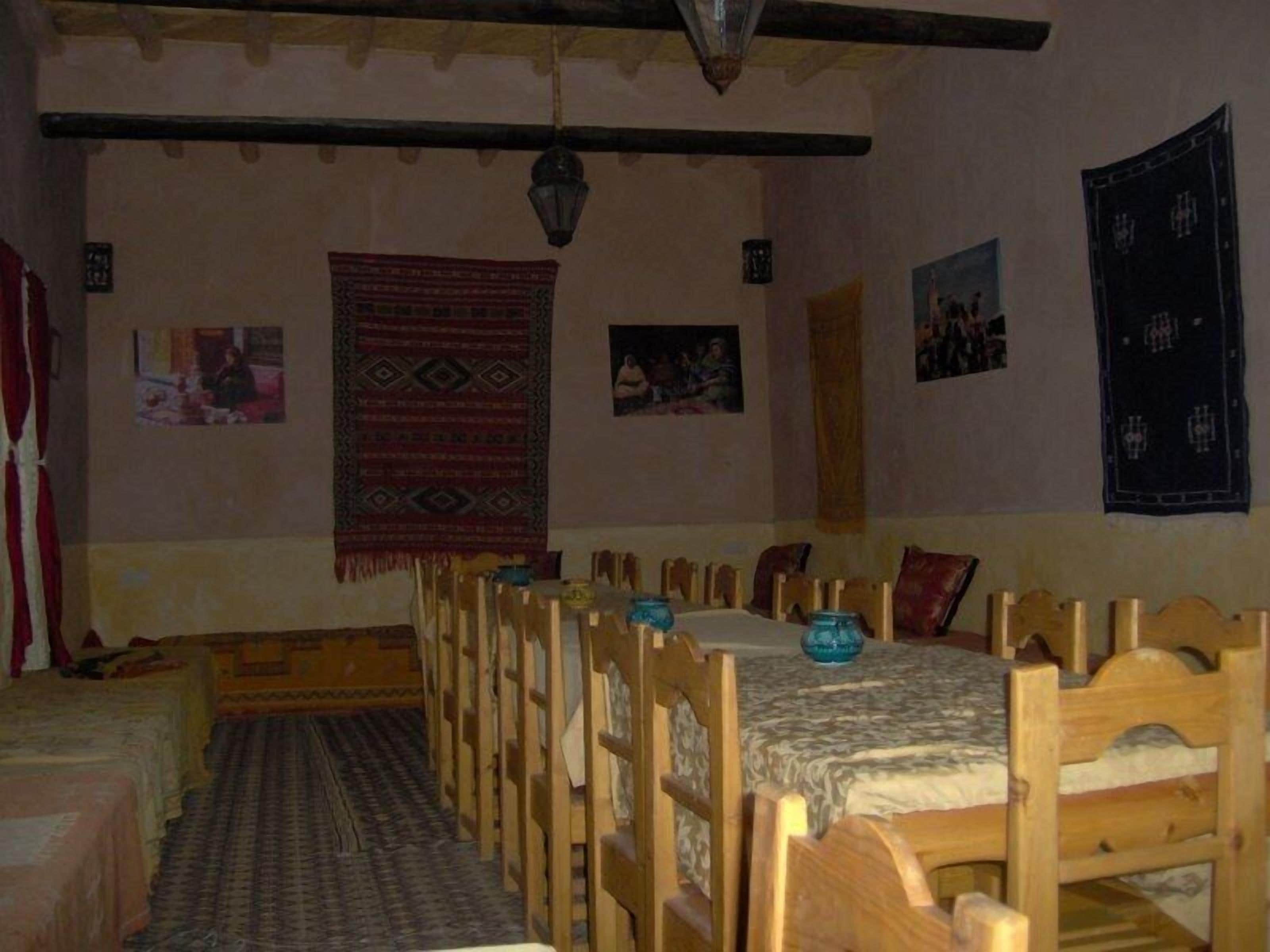 A traditional room with wooden furniture, patterned rugs, and wall hangings.