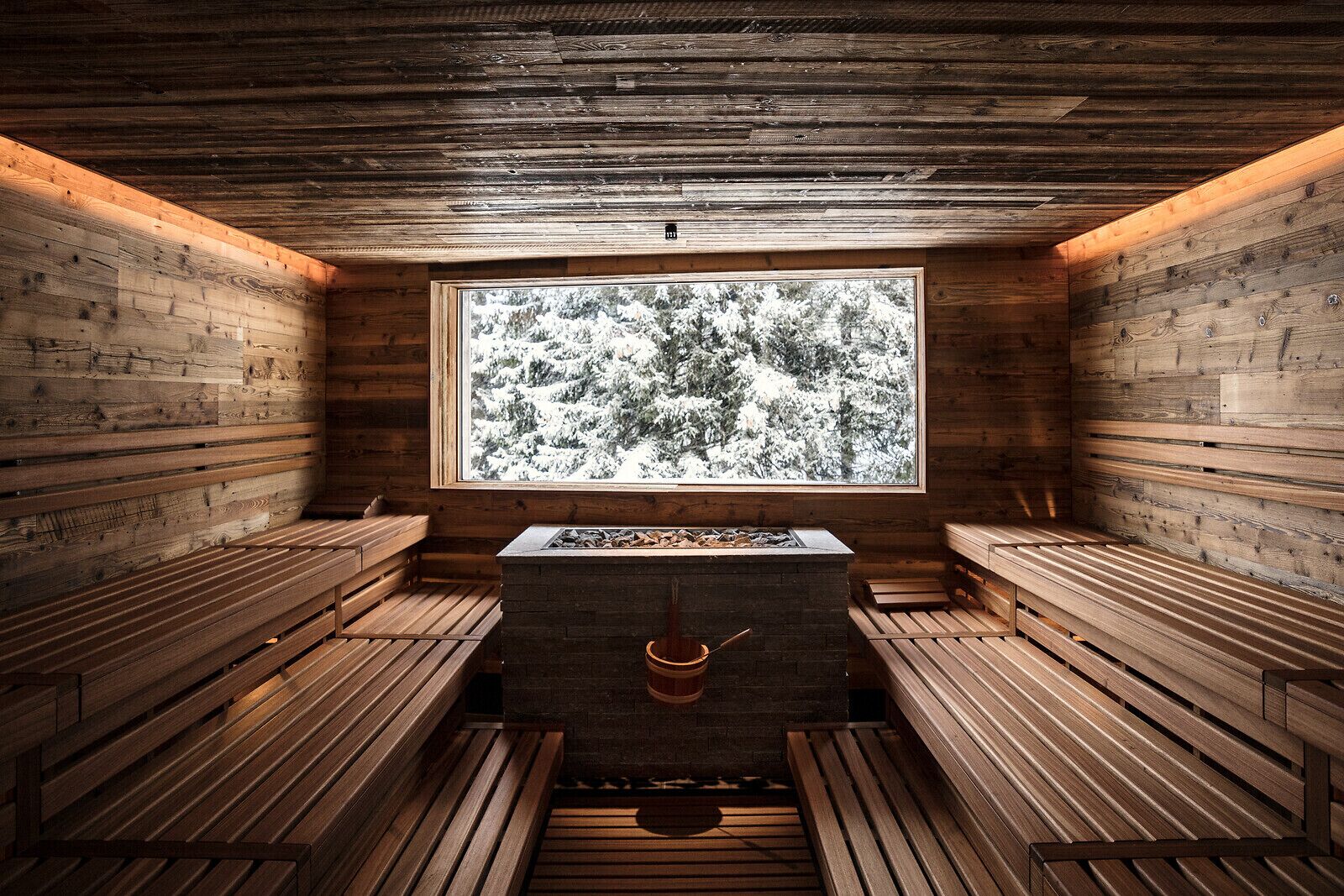 A sauna room with wooden benches and a large window.