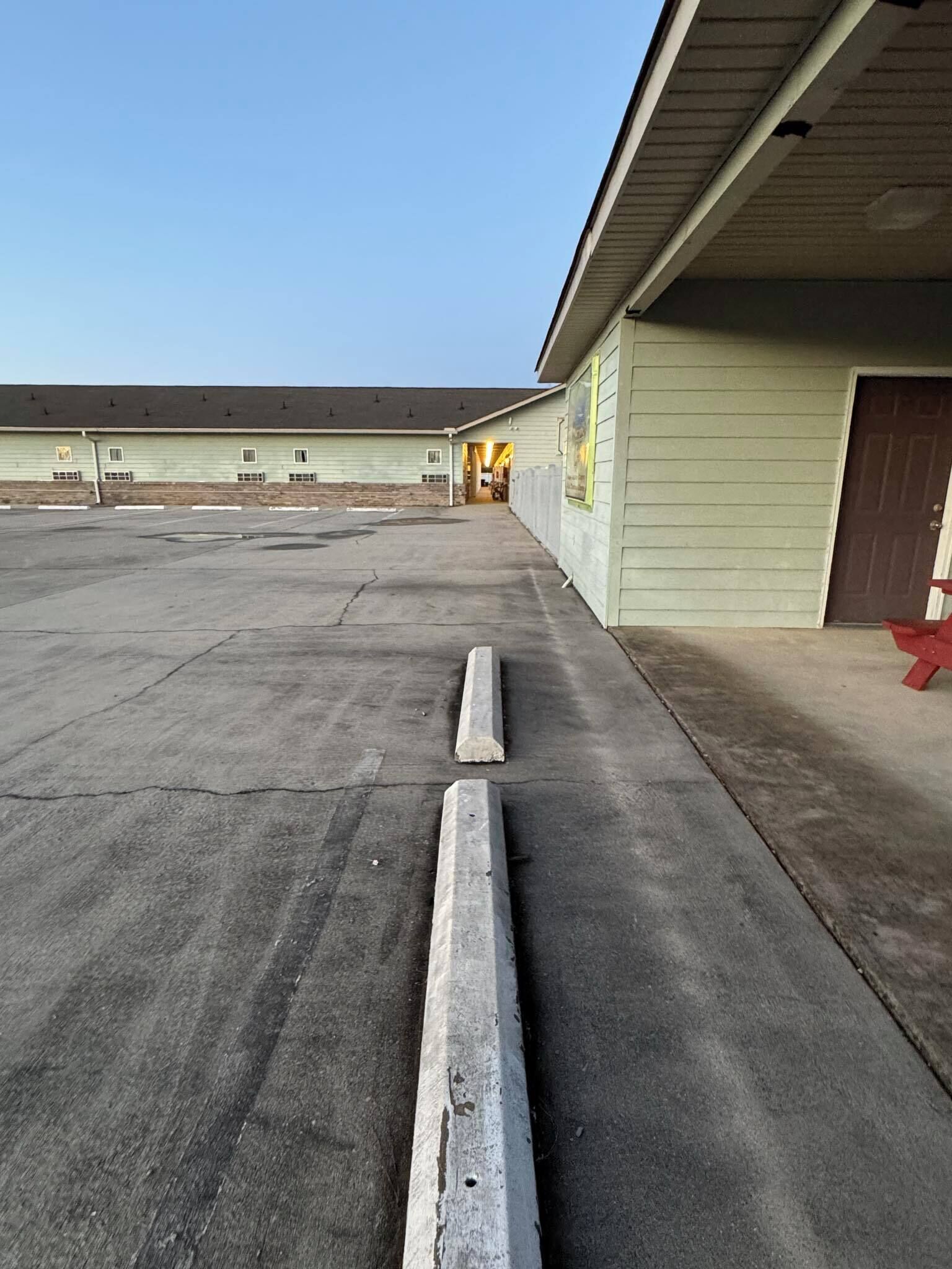 A parking lot with a building in the background.