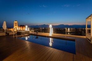 A rooftop pool area with a view of mountains, a bell tower, and a lounge with a hot tub. - Can Ribera By Zafiro (Muro)