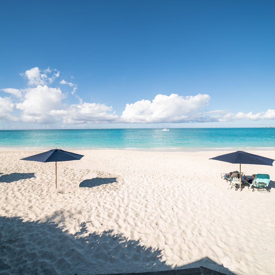 On the beach, white sand, sun loungers, beach umbrellas