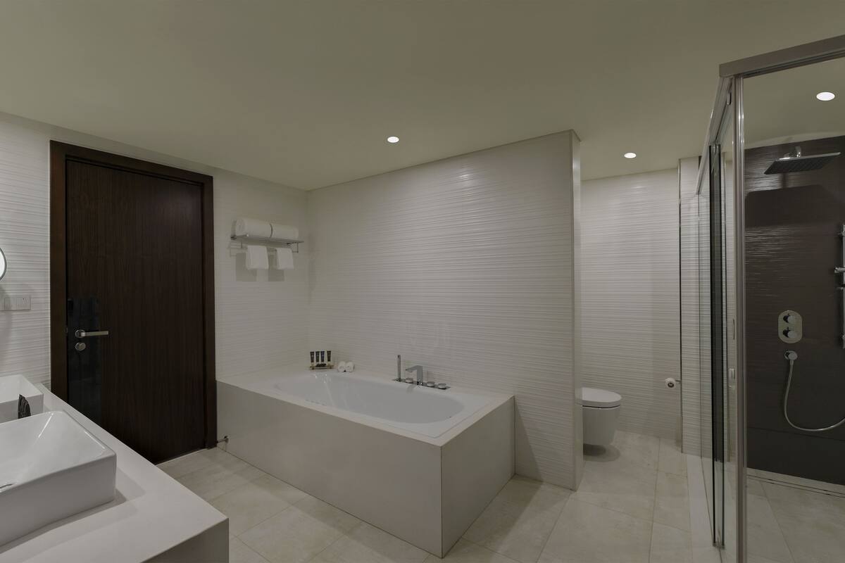 deluxe suite, 1 double bed with sofa bed | bathroom | rainfall showerhead, eco-friendly toiletries, hair dryer, bathrobes