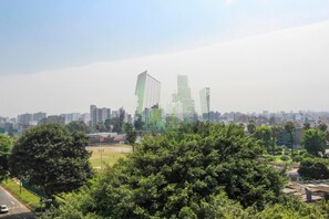 A cityscape with modern buildings and a park area.