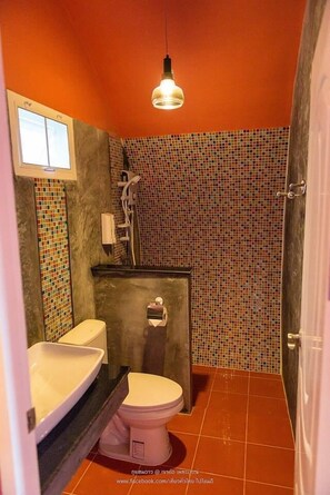 A bathroom with a tiled shower wall, a toilet, and a sink. - Phu Sandao Resort (Khao Kho)
