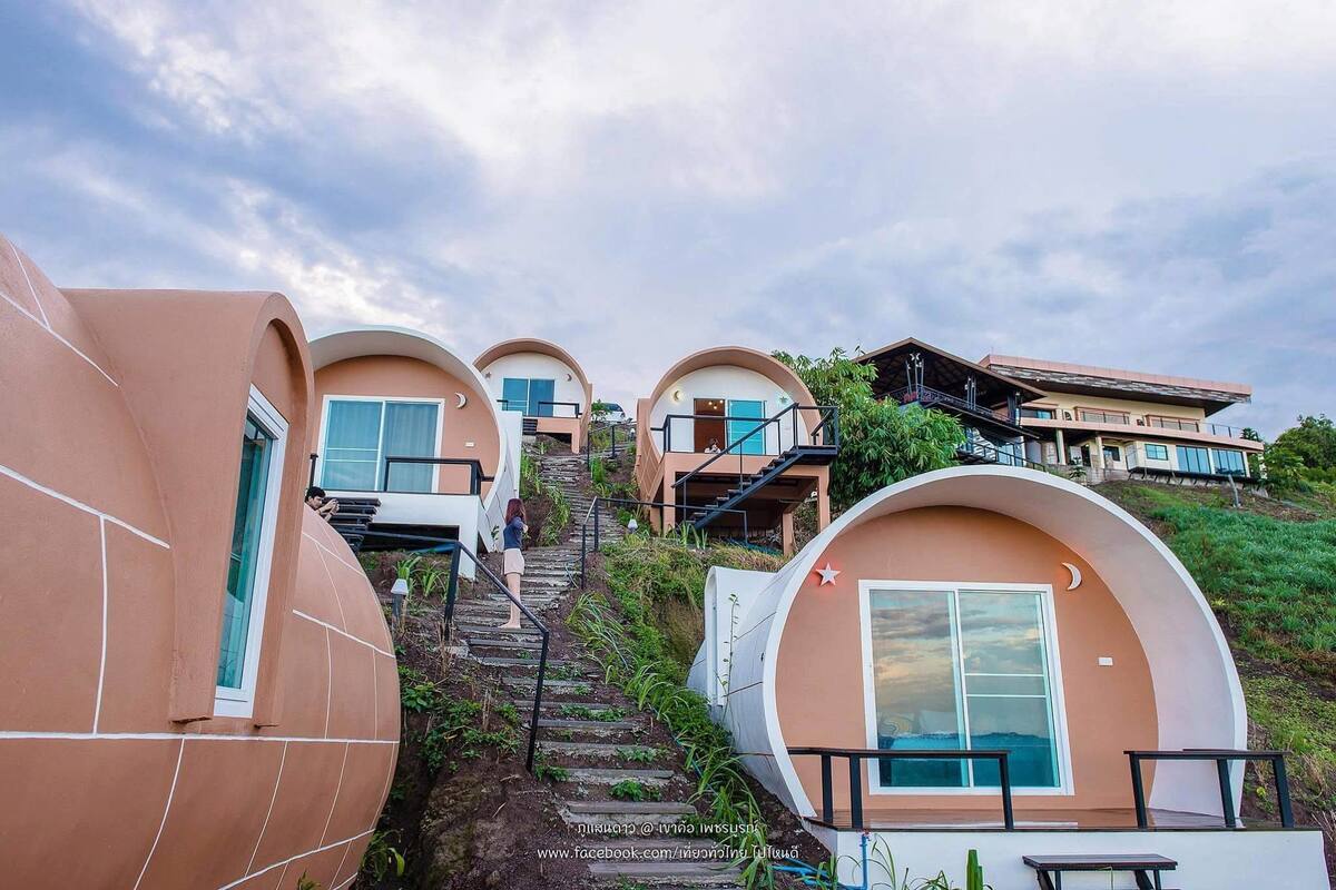 A series of dome-shaped buildings with external staircases leading to the entrance.