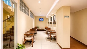A hotel room with a staircase, a TV mounted on the wall, and a sign indicating room number B130-B142. - Subwow Hostel (Bandung)