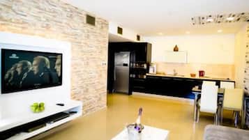 Apartment, 1 Bedroom, Balcony | Living area | Flat-screen TV, pay films