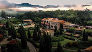 A large estate with multiple buildings, a swimming pool, and well-manicured gardens. - La Toscana Resort (Suan Phueng)