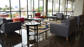 A modern lobby with large windows, a marble floor, and contemporary furniture. - Casa Bonita Hotel (Malacca City)