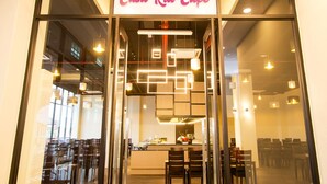 The exterior of Casa Ria Cafe with a modern interior visible through the glass doors. - Casa Bonita Hotel (Malacca City)