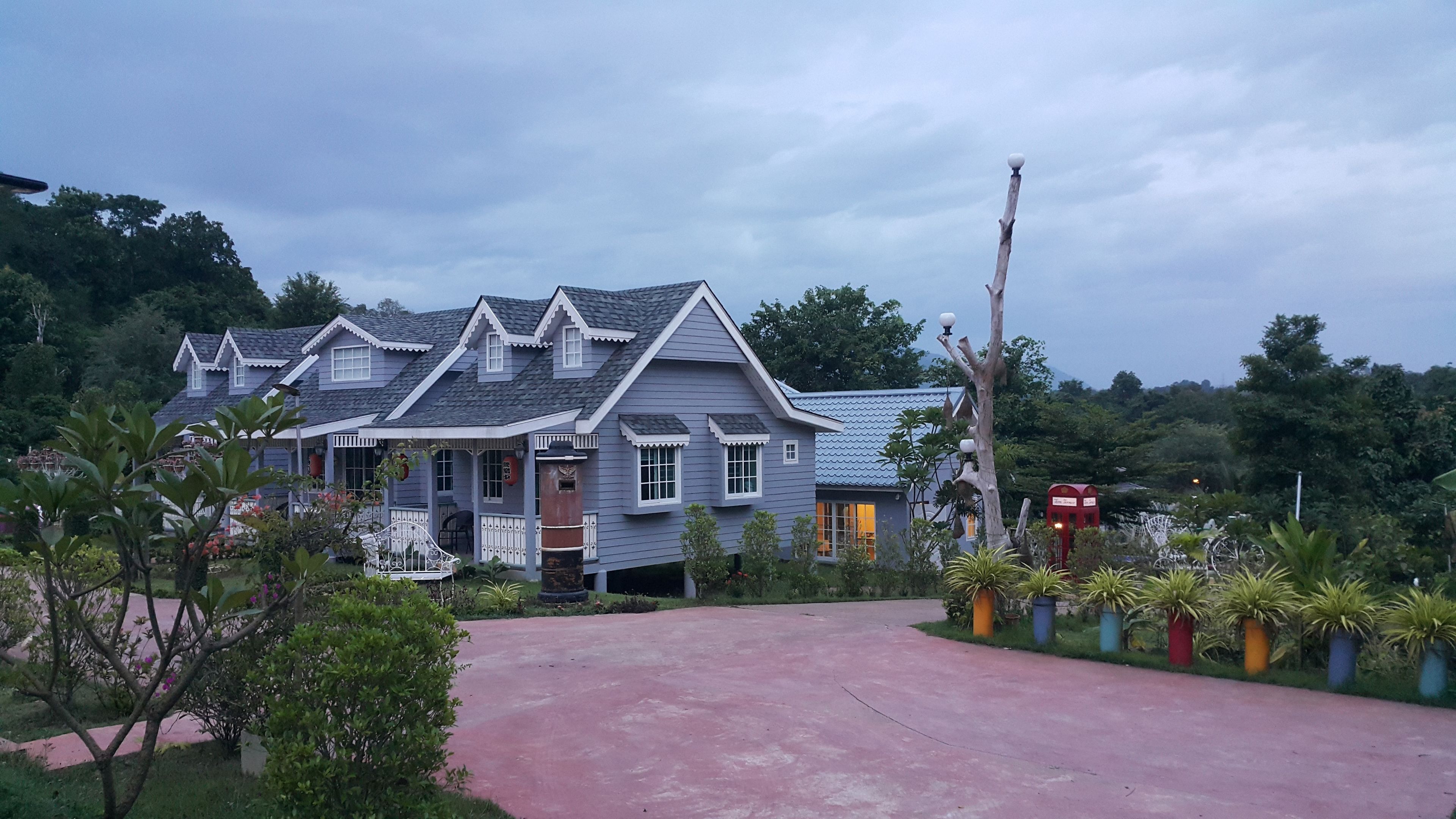 A traditional house with a sloped roof and a porch.