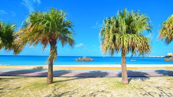 On the beach, white sand, beach umbrellas, beach towels