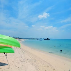 On the beach, white sand, beach umbrellas, beach towels