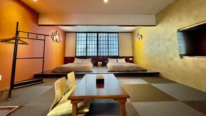 A modern hotel room with a large bed, a dining table, and a seating area. - Araha Resort ARAPANA (Chatan)