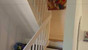 A staircase with white railings and dark wooden steps. - Malley House (Healesville)