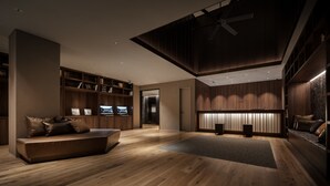 A modern interior with a wooden floor, built-in shelving, a seating area, and a ceiling fan. - Nest Hotel Tokyo Hanzomon (Tokyo)