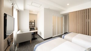 A hotel room with a bed, a desk, a chair, a wardrobe, and a television. - Tissage Hotel Naha (Naha)