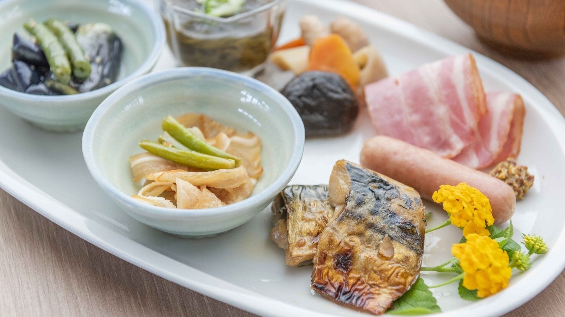 A plate with various food items including fish, vegetables, and meat.