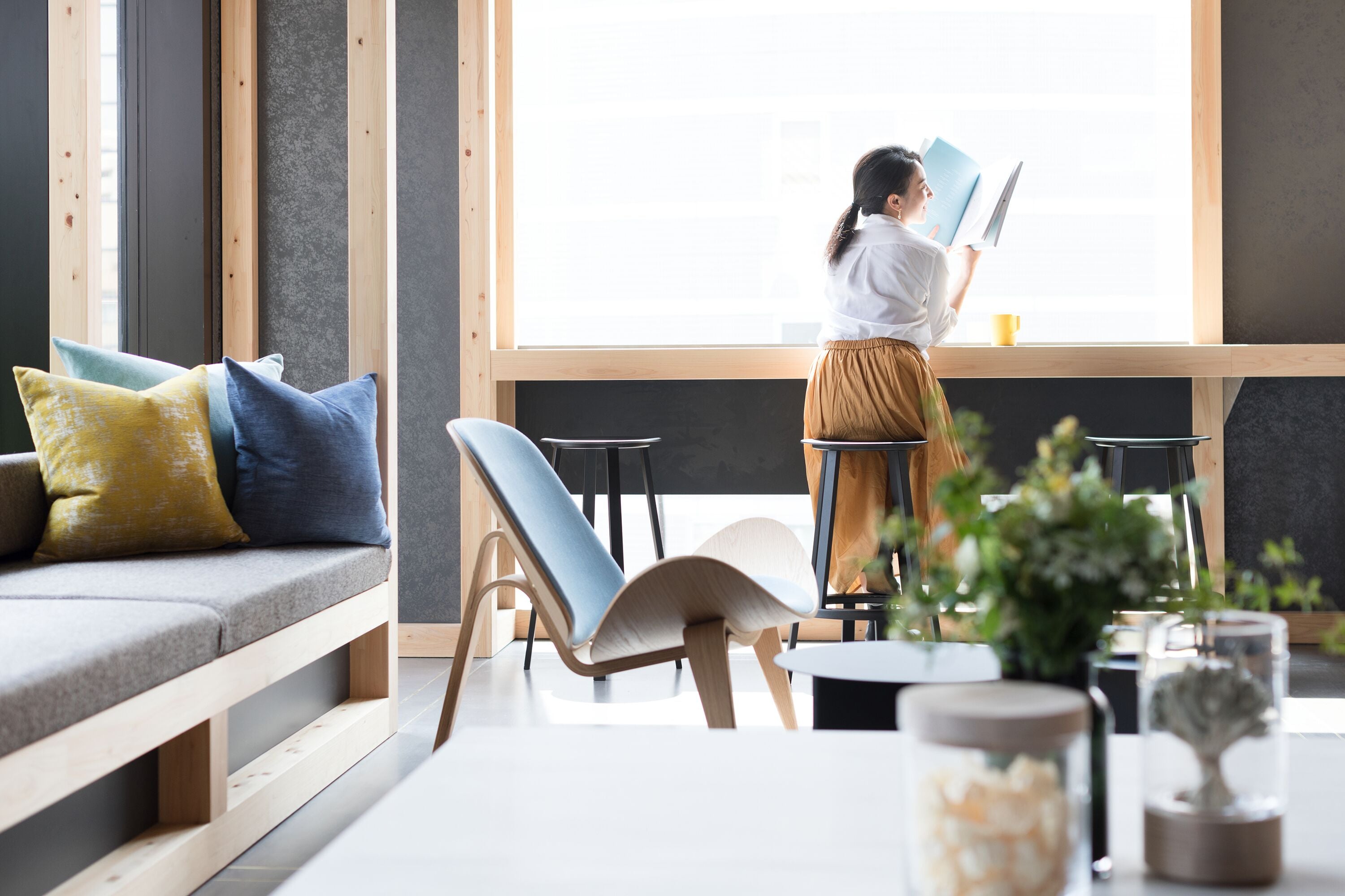 A modern interior with a sofa, chairs, and a table with decorative items.