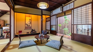 A traditional Japanese room with tatami flooring, a low table, and shoji screens. - Inari Ohan (Kyoto)