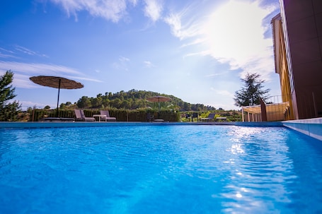 Seasonal outdoor pool, open 10:00 AM to 8:00 PM, sun loungers