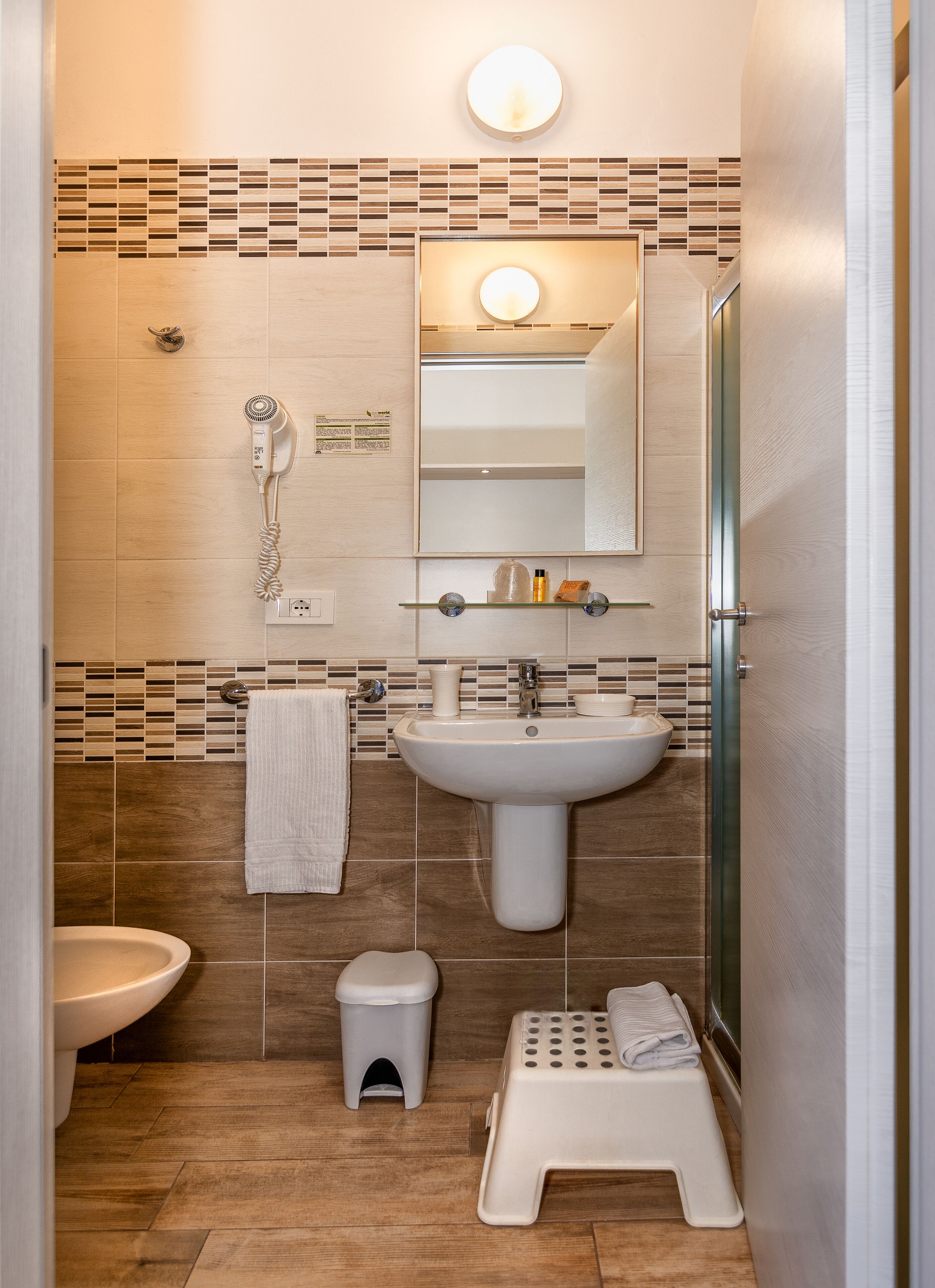 A bathroom with a sink, toilet, and shower.