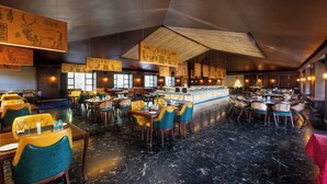 A spacious restaurant with high ceilings, marble flooring, and a central bar area. - Mahua Bagh Resort (Kumbhalgarh)