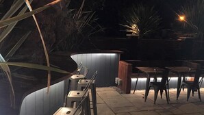 An outdoor patio area with seating arrangements and ambient lighting. - Oxgang Kitchen Bar & Rooms (Grangemouth)