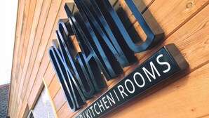 A sign with the words "BAR KITCHEN ROOMS" on a wooden wall. - Oxgang Kitchen Bar & Rooms (Grangemouth)