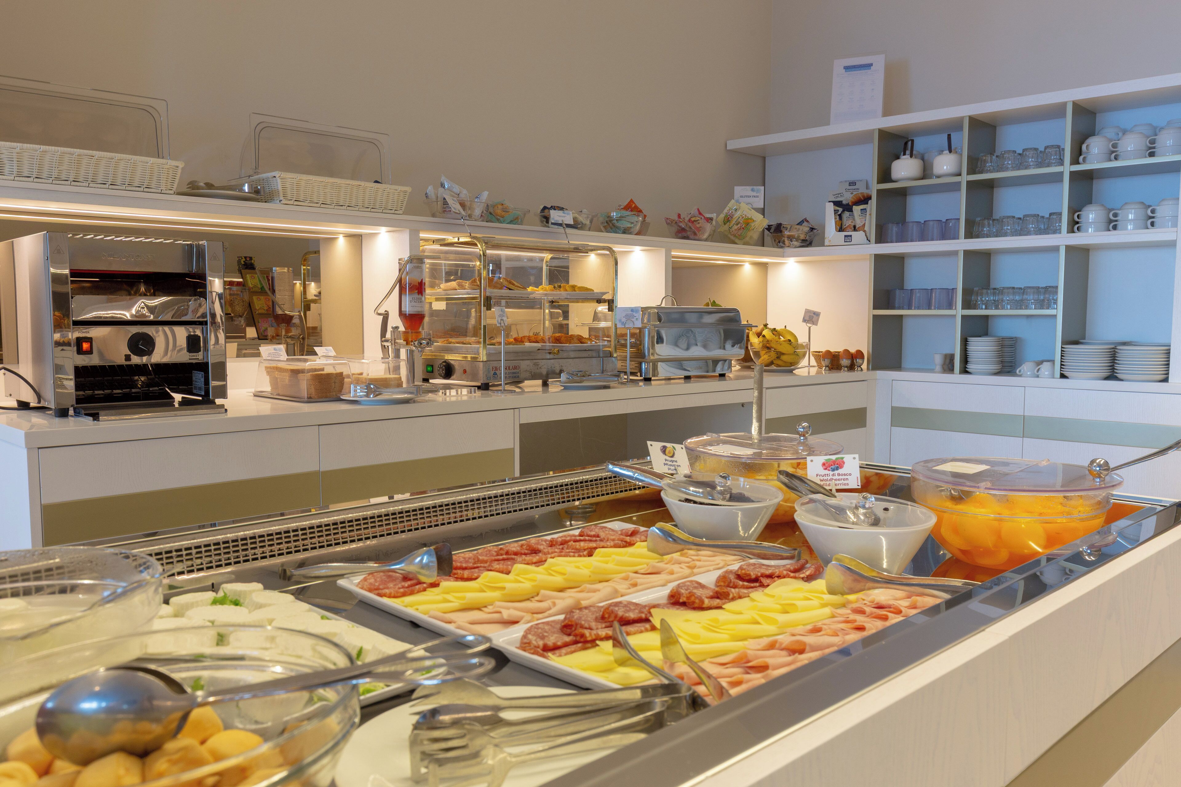 A buffet with various food items and utensils.