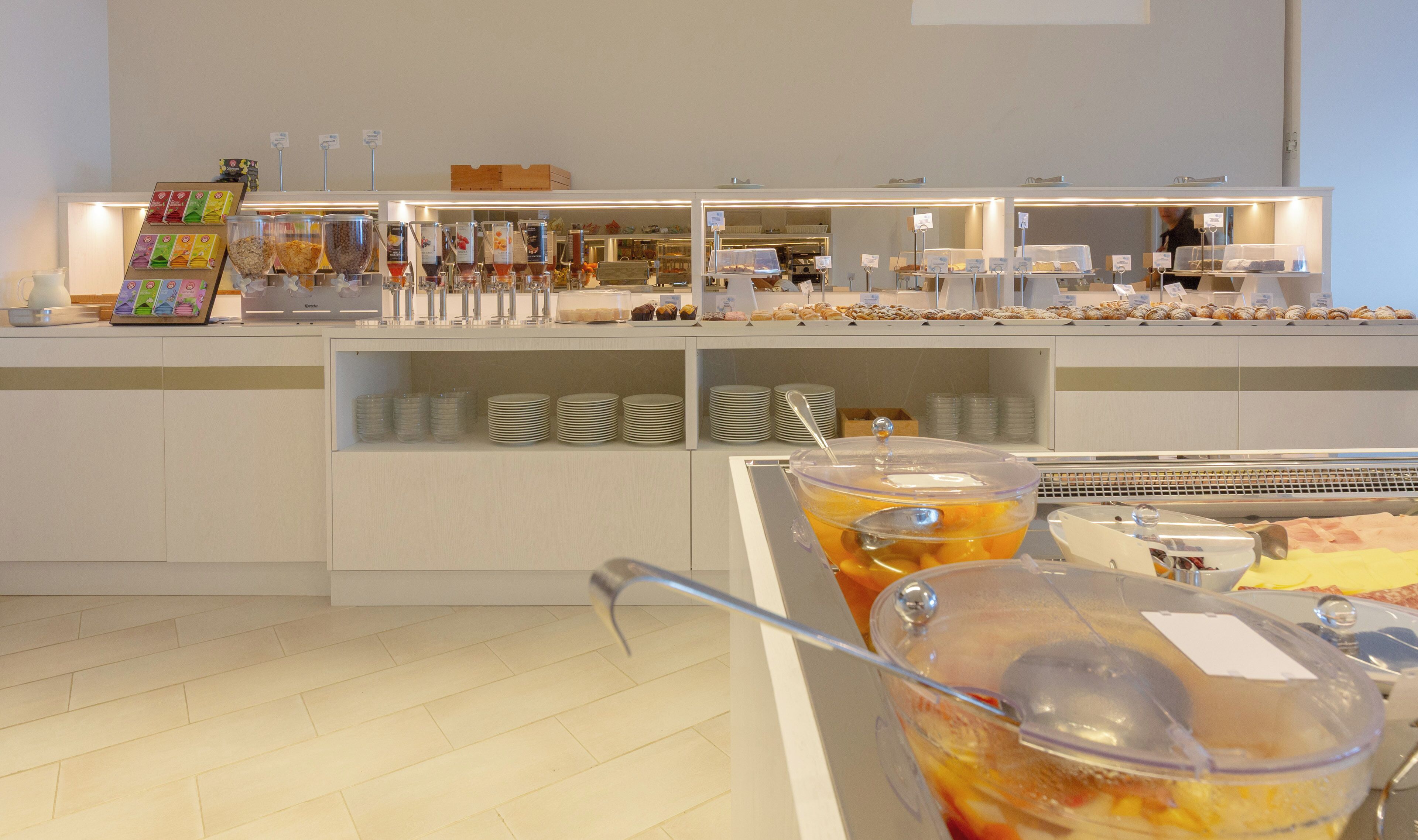 A buffet area with various food items and beverages.